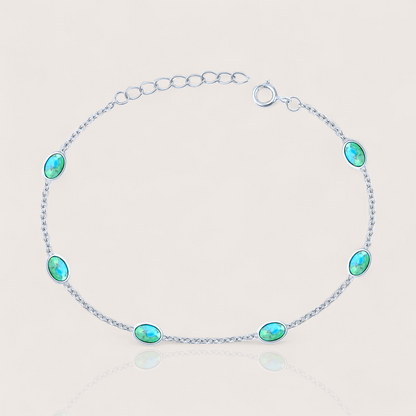 Close-up of sterling silver turquoise station bracelet with 6 oval turquoise stones