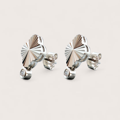 Pair of silver earrings with a diamond cut pattern geometric 4-leaf clover design and a sparkling solitaire cubic zirconia gemstone.