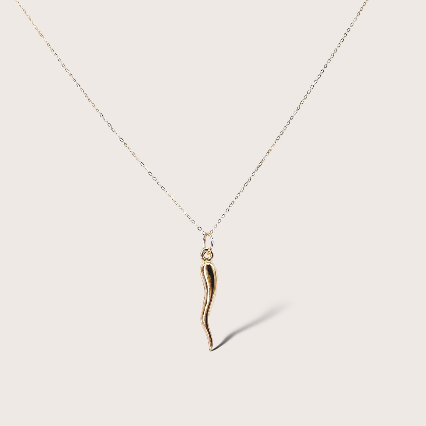 14K Solid Gold Chain with 14K Solid Gold Hollow 3D Puffed Horn Pendant. This exquisite pendant is crafted from 14K solid gold and features a hollow 3D puffed horn design. It is available in two sizes of horn pendants, small and large, and in lengths ranging from 16 inches to 18 inches. This image is with the large horn