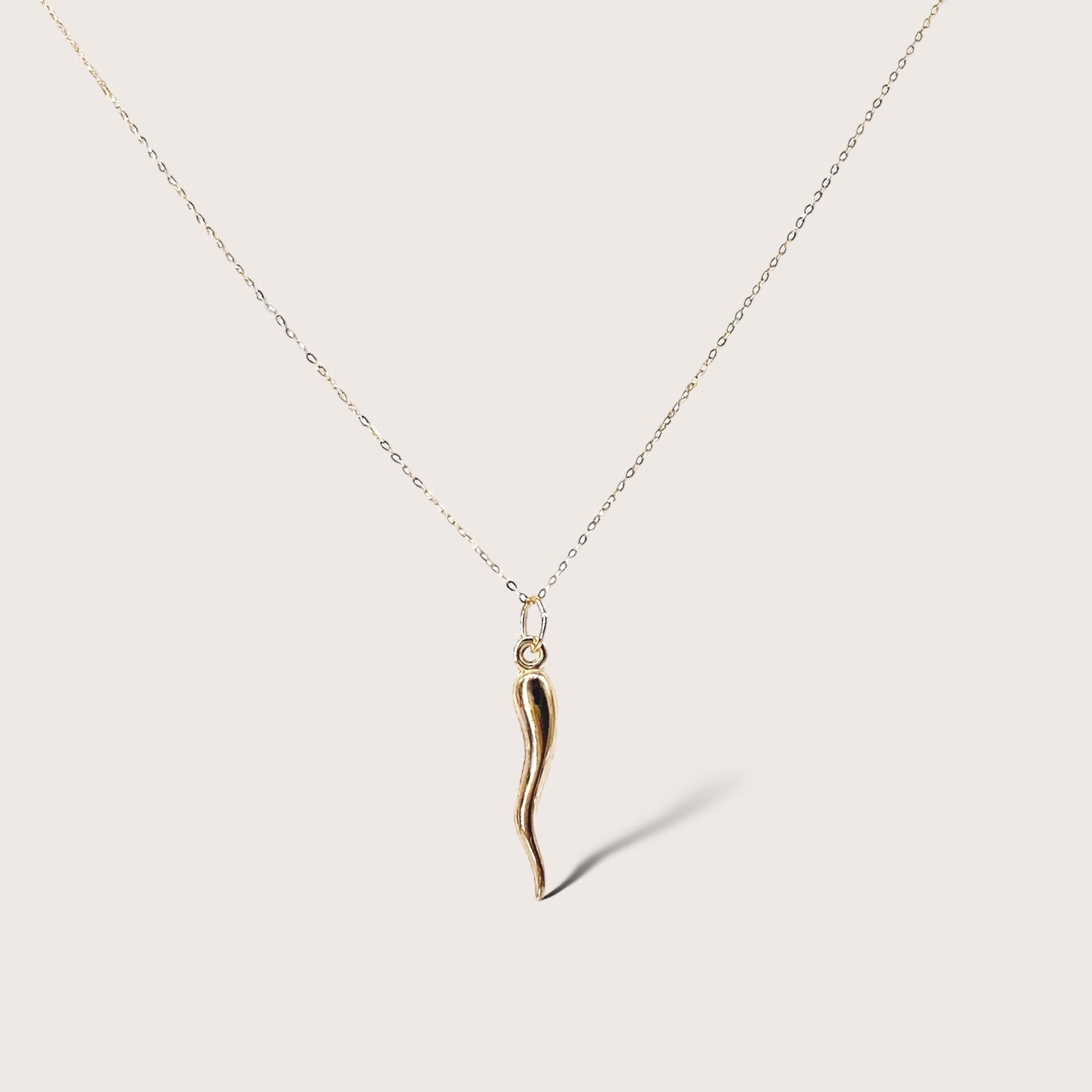 14K Solid Gold Chain with 14K Solid Gold Hollow 3D Puffed Horn Pendant. This exquisite pendant is crafted from 14K solid gold and features a hollow 3D puffed horn design. It is available in two sizes of horn pendants, small and large, and in lengths ranging from 16 inches to 18 inches. This image is with the large horn