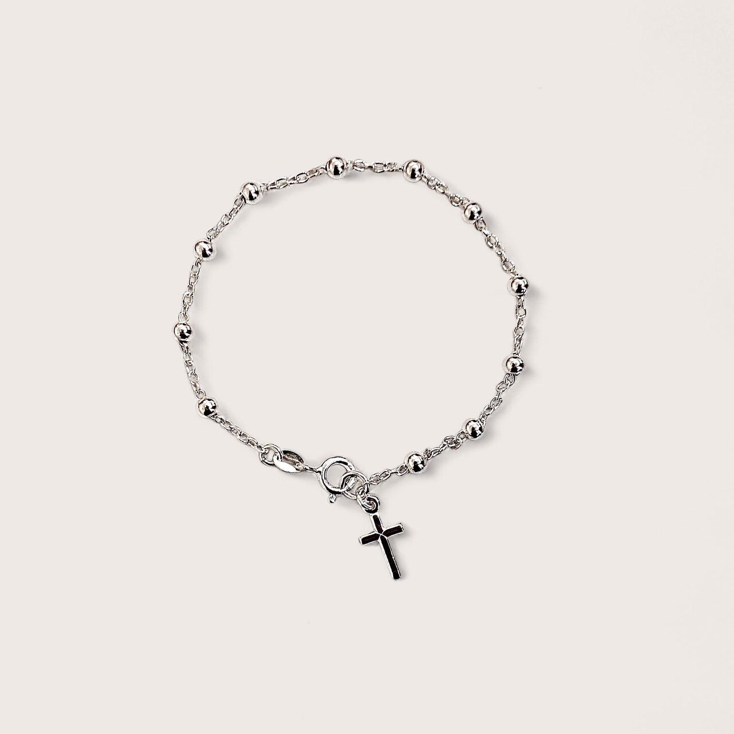 Enhance your spiritual and fashionable attire with this exquisite rosary bead bracelet crafted from 925 sterling silver. The bracelet features a delicate Christian cross pendant, elegantly crafted and finished in lustrous sterling silver.