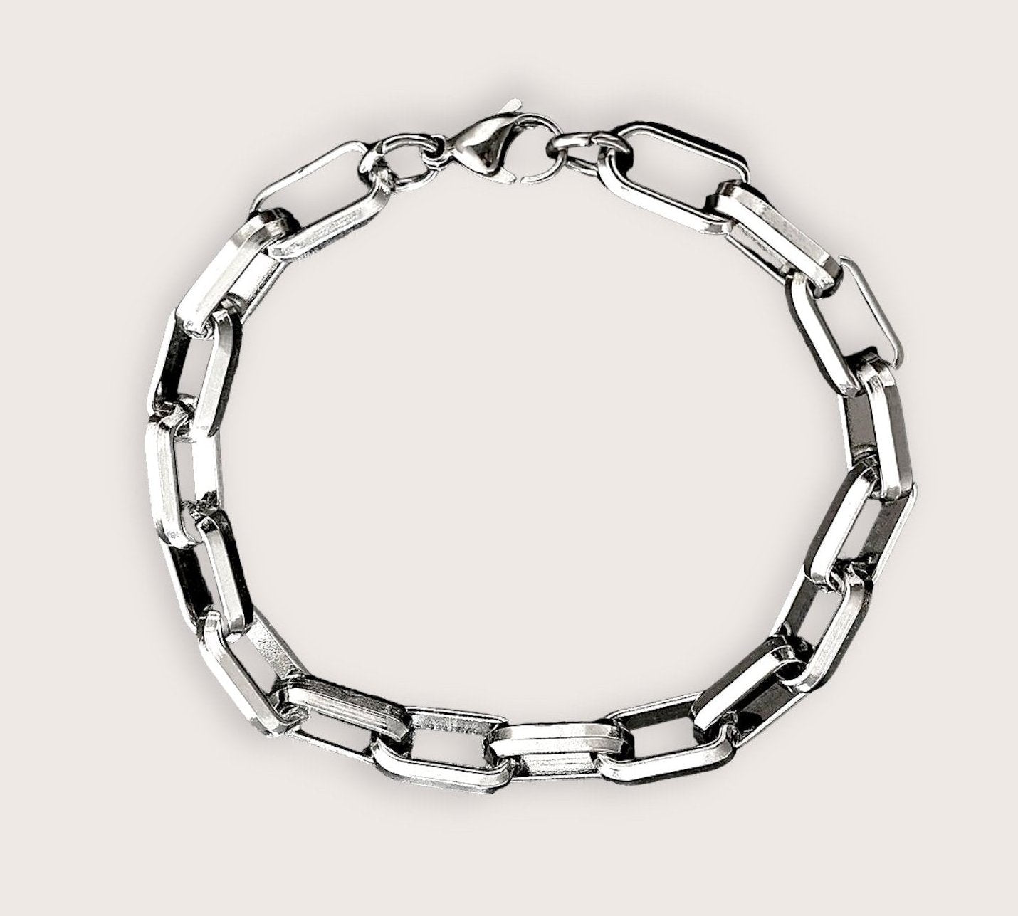 A stainless steel bracelet with a robust and sophisticated design, featuring a series of interlinked metal rings.