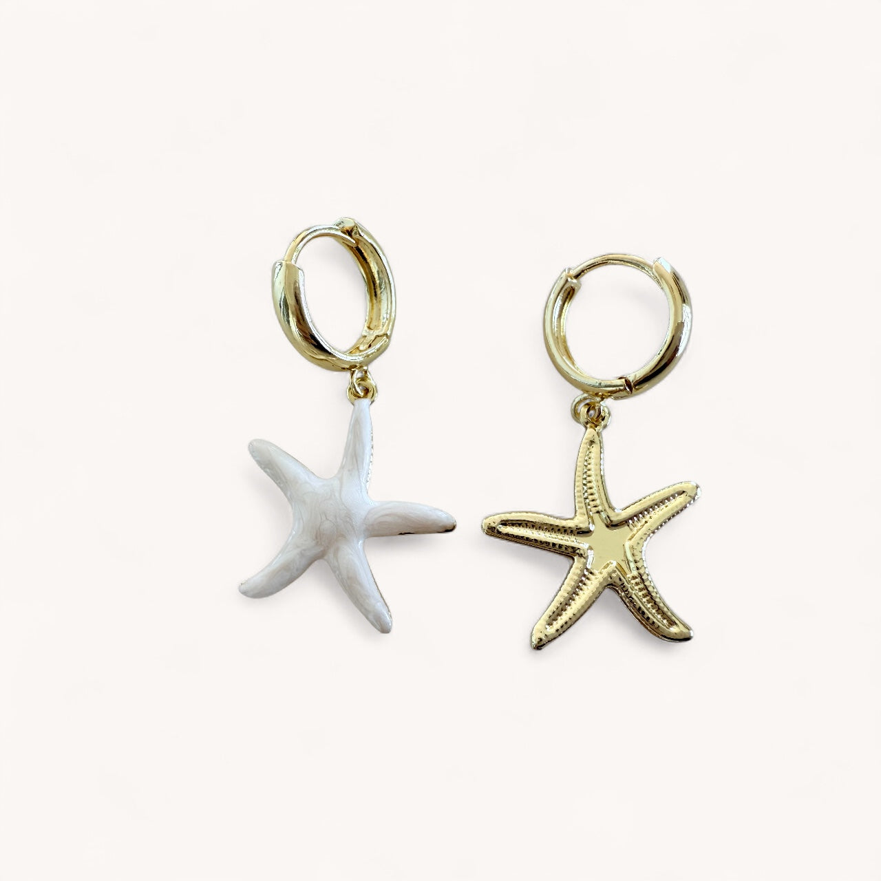 Pair of gold dangle huggie hoop earrings with starfish charms, showing front side and backside