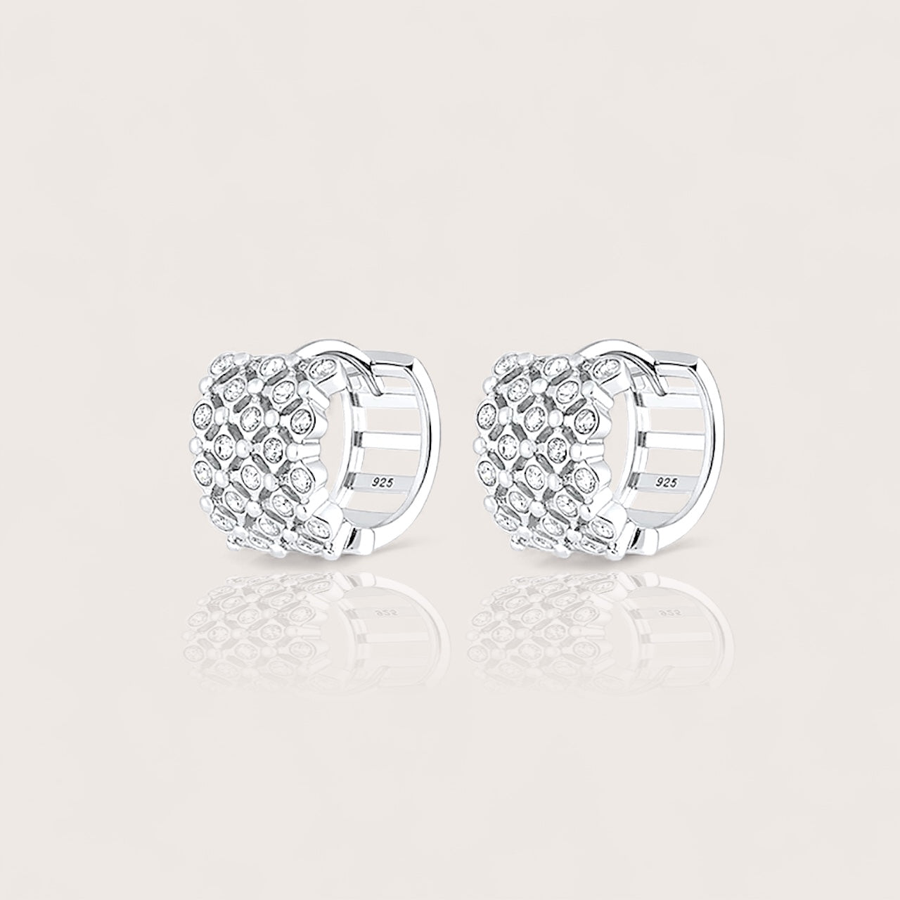 Silver huggie hoop earrings with clear cz gemstones and a secure latch back closure