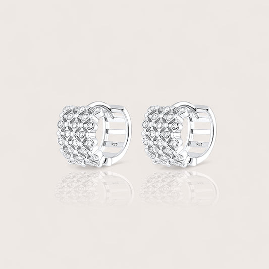 Silver huggie hoop earrings with clear cz gemstones and a secure latch back closure