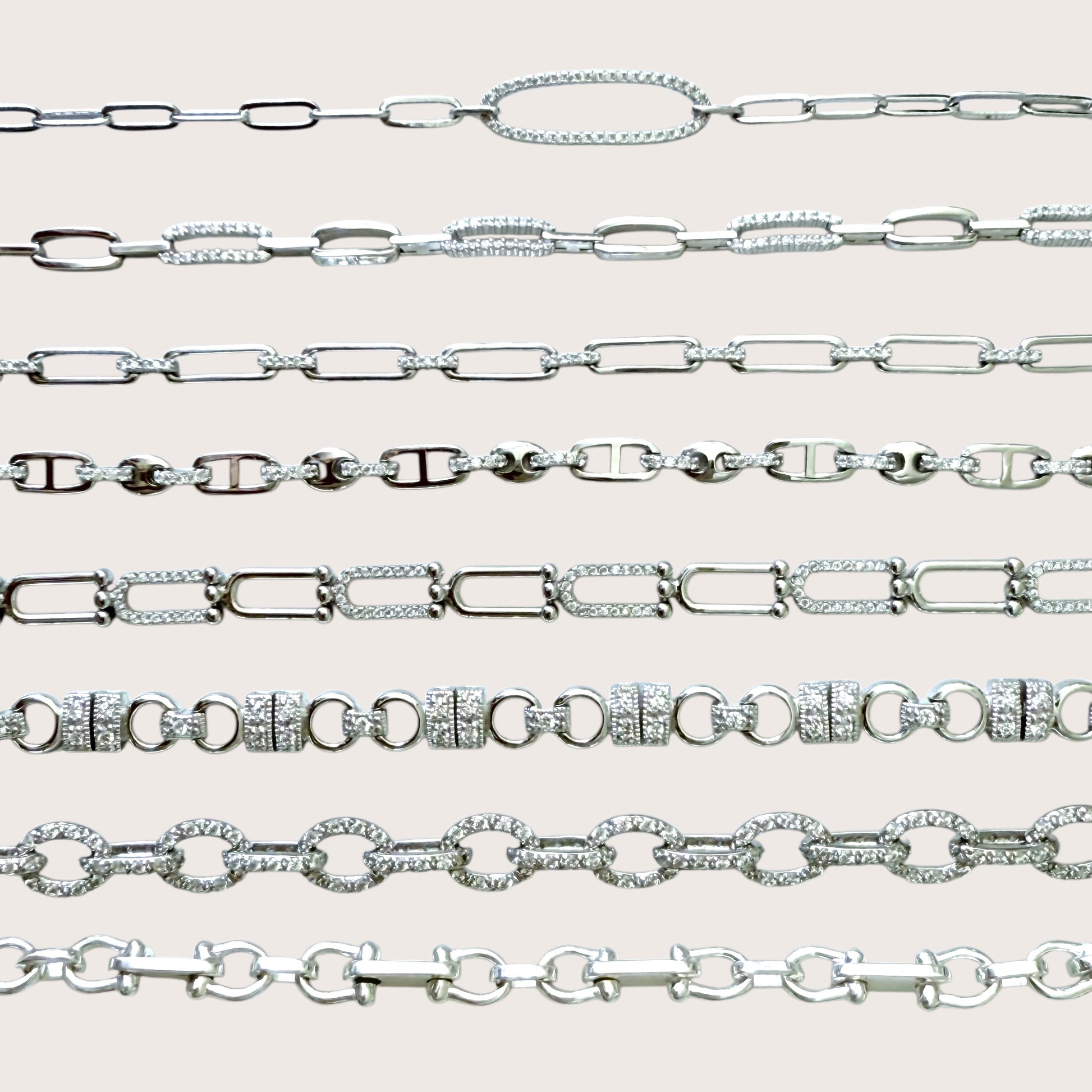 Collection of silver chain bracelets  on a light gray background