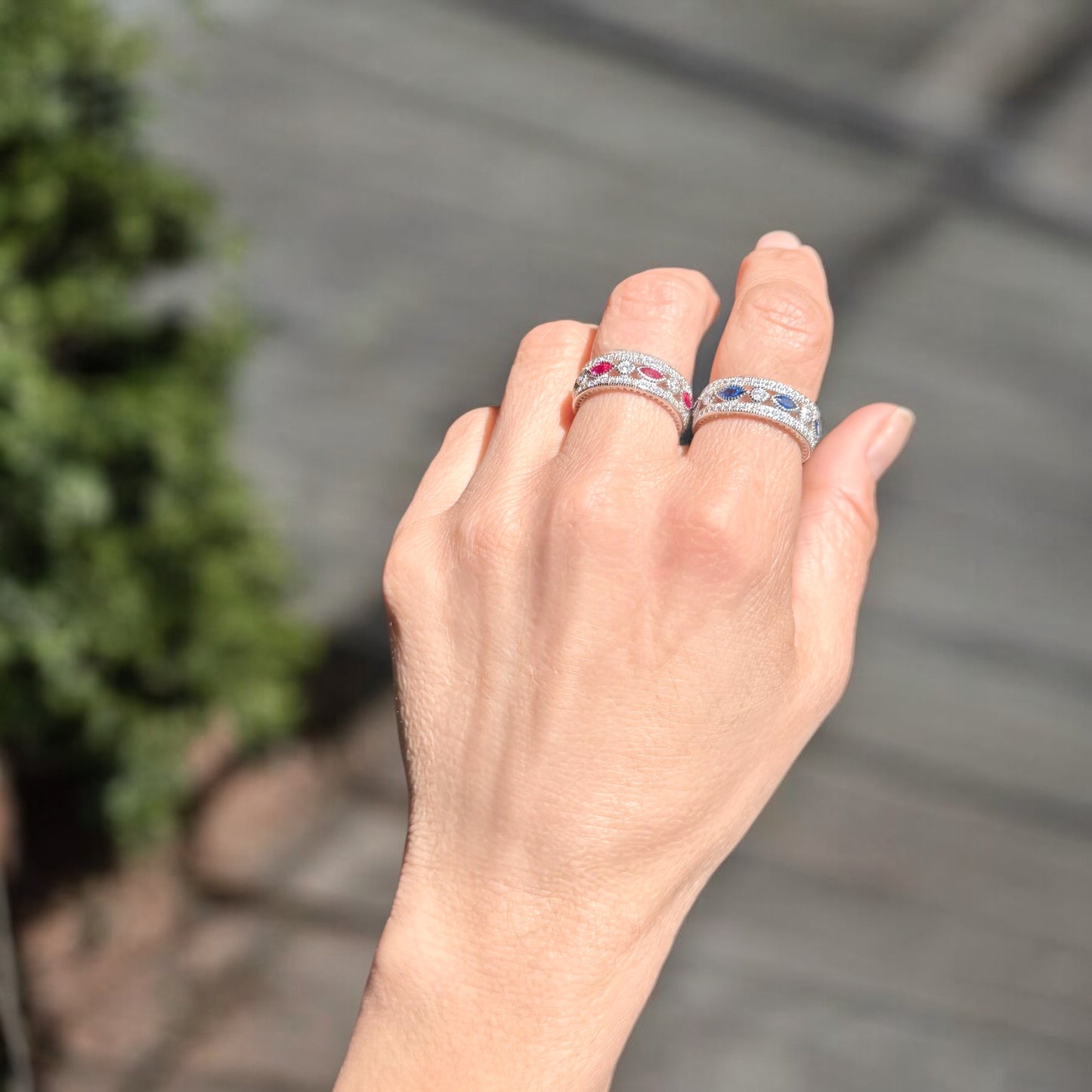 Model wearing both pink and sapphire eternity rings 
