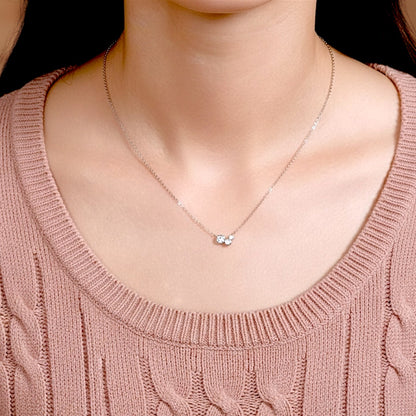 Dainty Moissanite cluster necklace shown on a model to demonstrate the 16-inch adjustable chain length and minimalist style.
