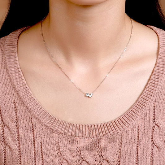 Dainty Moissanite cluster necklace shown on a model to demonstrate the 16-inch adjustable chain length and minimalist style.