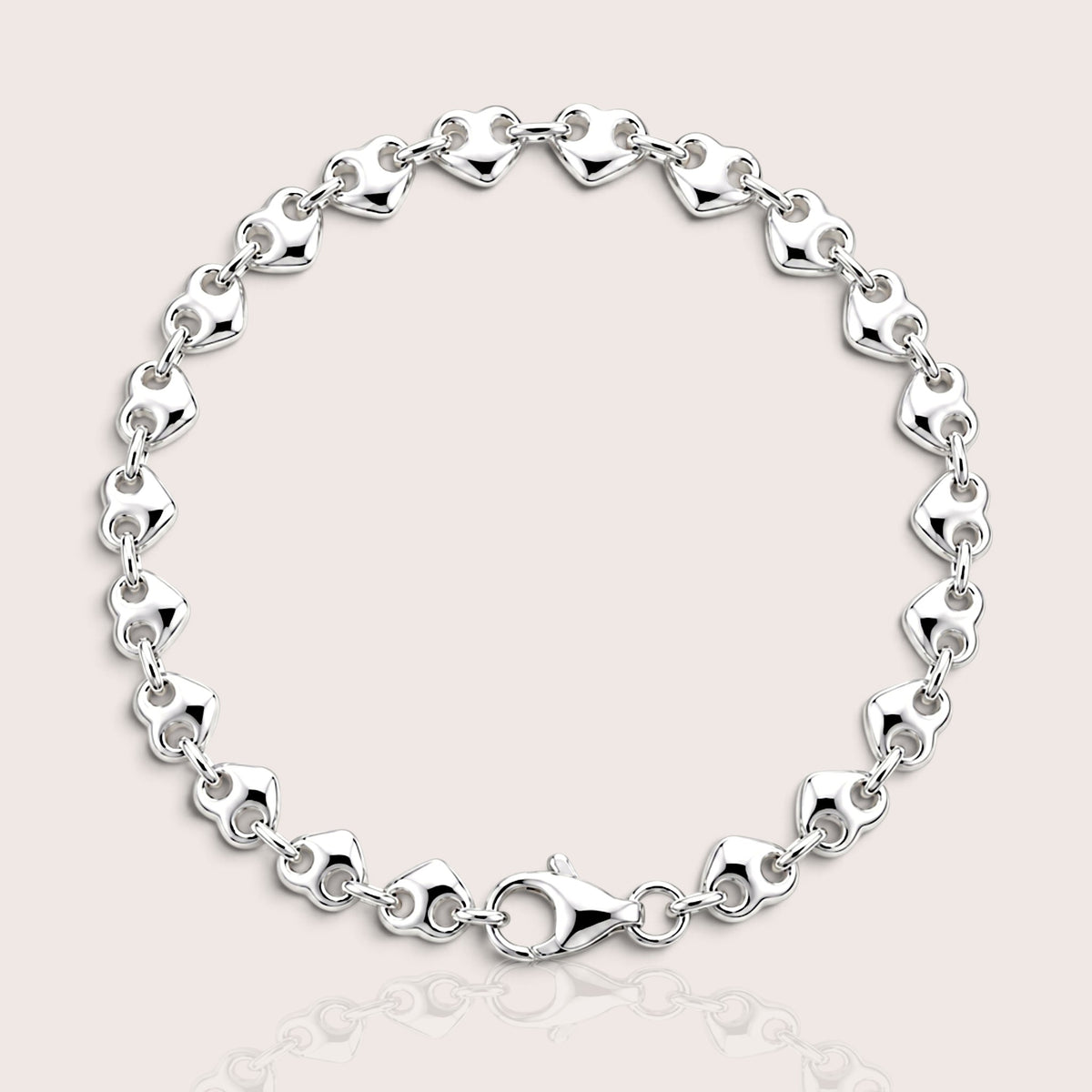 Polished silver puffed heart link bracelet arranged in a circle with the lobster clasp visible.