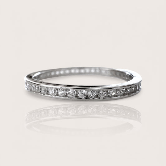 Sterling Silver and Swarovski Crystals Eternity Band, channel set 1.7mm wide band features round-cut Swarovski Crystals that sparkle. The luxurious rhodium finish ensures long-lasting wear. Elevate your style with this timeless piece.