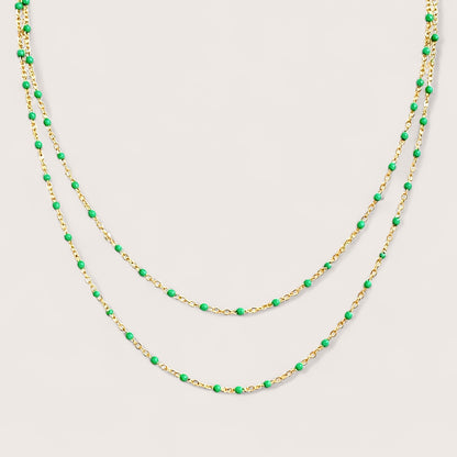 Macro view of the delicate station necklace showcasing the smoothly integrated emerald green enamel stations and certified 14/20 gold filled components.
