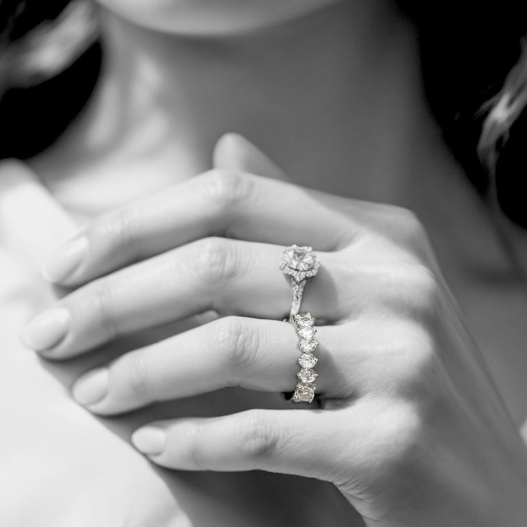 Model wearing a sterling silver cz eternity ring stacked with another ring