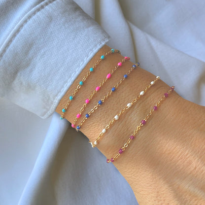 Minimalist wrist stack featuring the colorful enamel satellite chain bracelets stacked by Ashley Nicole Jewelry 