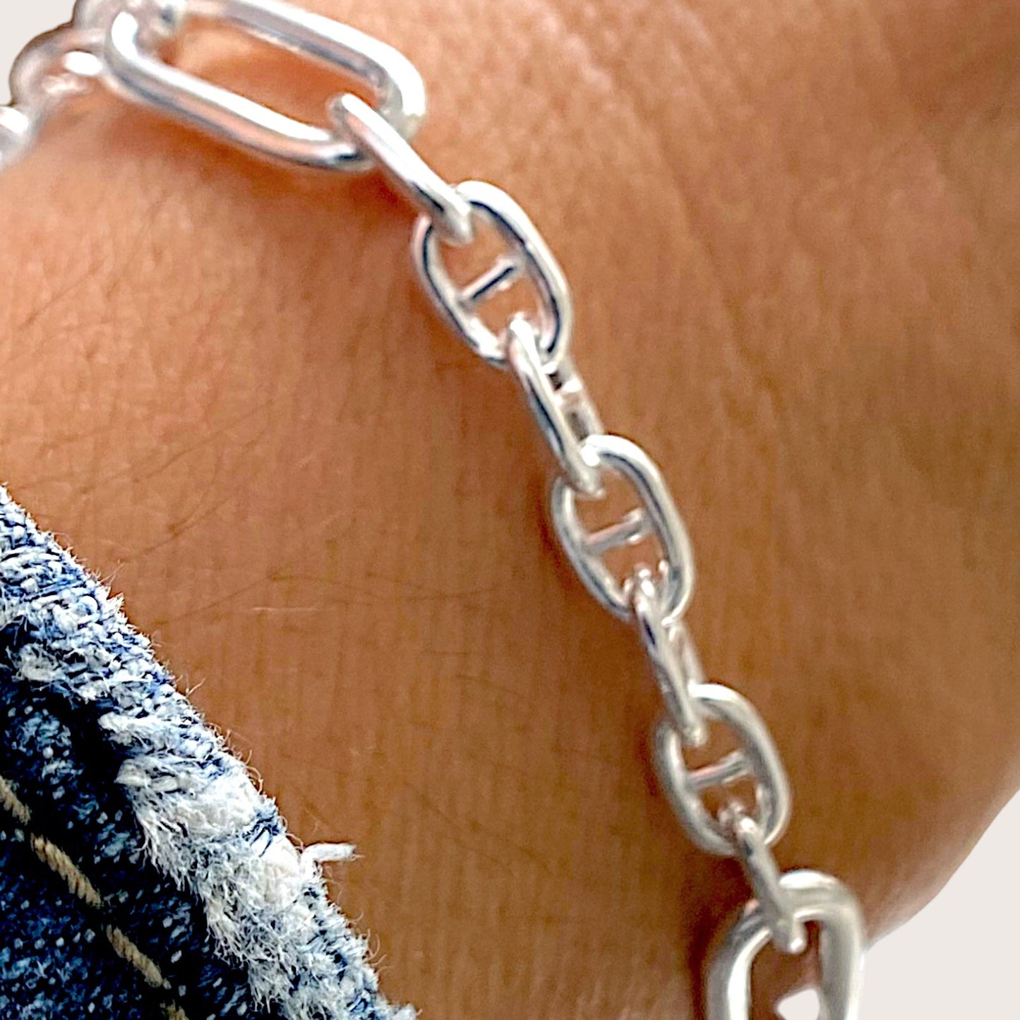 close up of silver puffed anchor link style chain