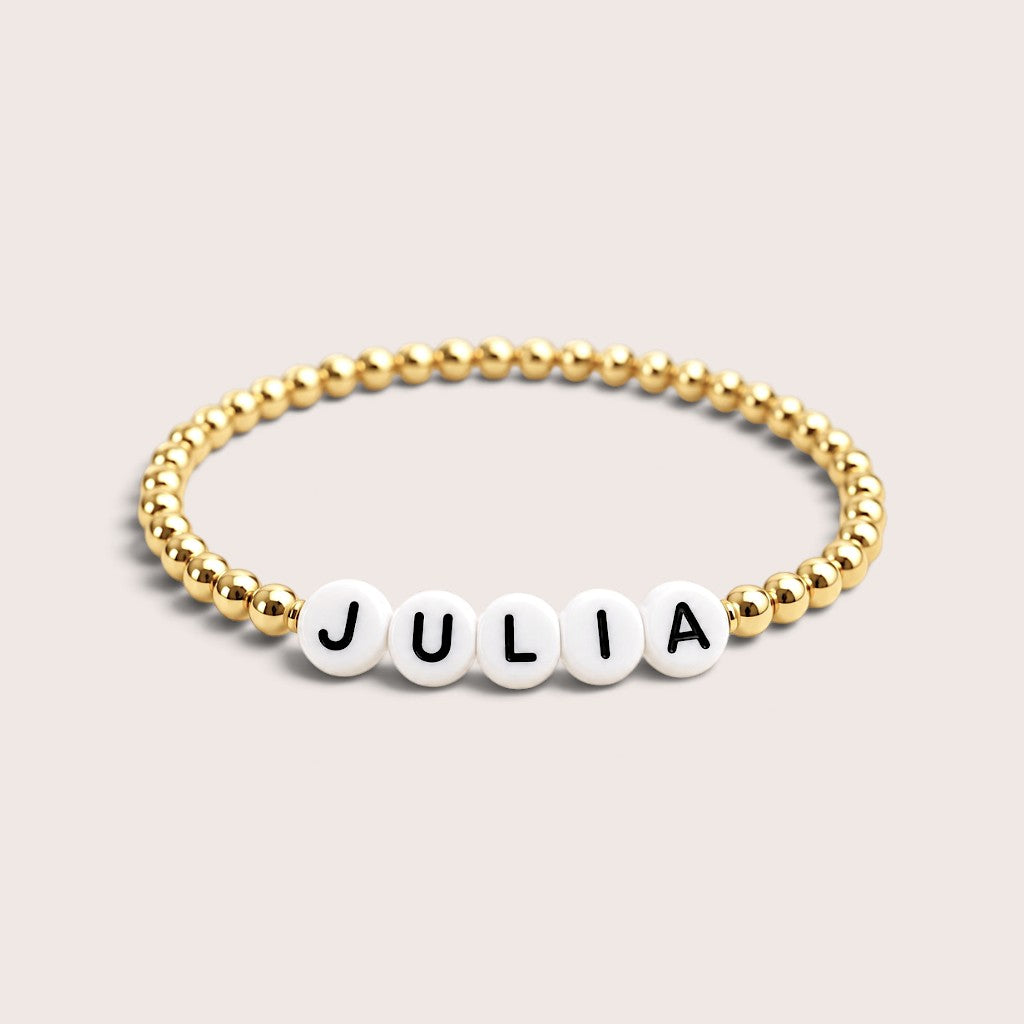 Beaded custom name bracelet with gold-filled beads and white acrylic letter beads