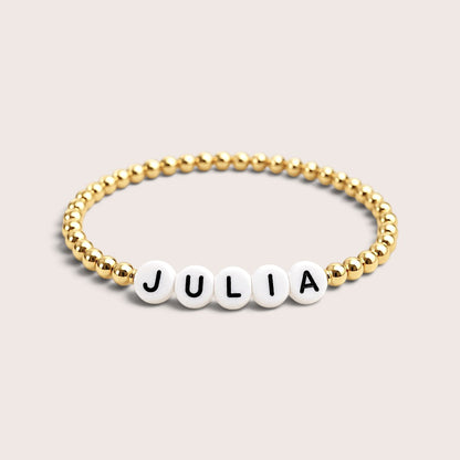 Beaded custom name bracelet with gold-filled beads and white acrylic letter beads