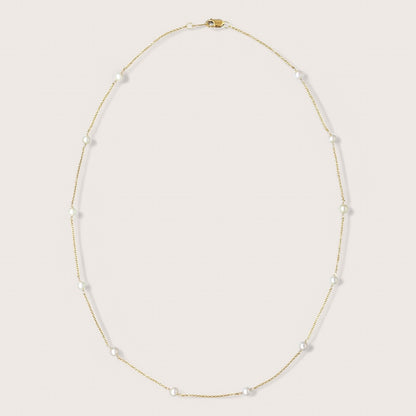 Full freshwater pearl station necklace arranged in an oval on a light background