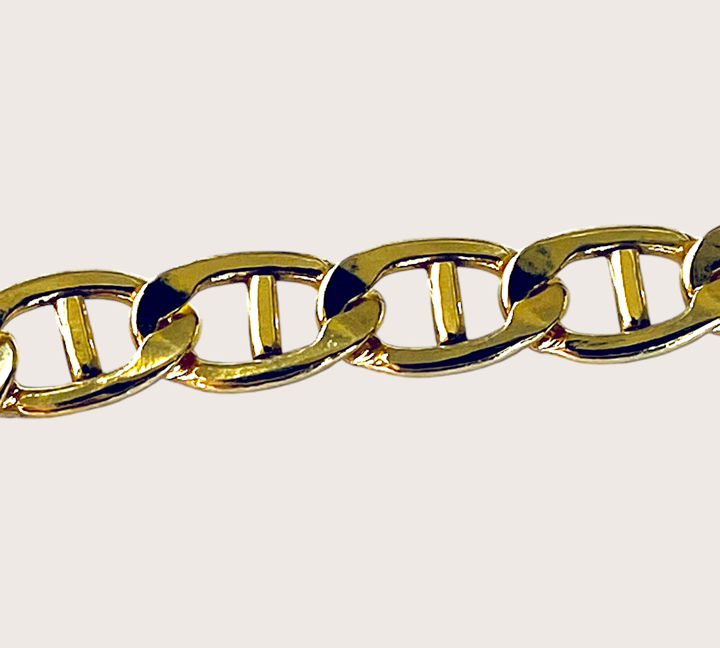 Close up image of polished 14k gold filled flat mariner anchor link chain bracelet lying flat  by Ashley Nicole Jewelry⁠