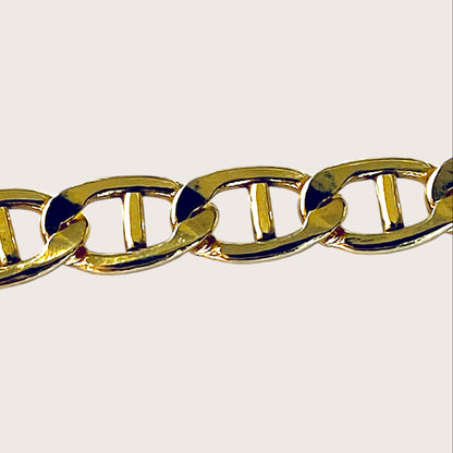Close up image of polished 14k gold filled flat mariner anchor link chain bracelet lying flat  by Ashley Nicole Jewelry⁠