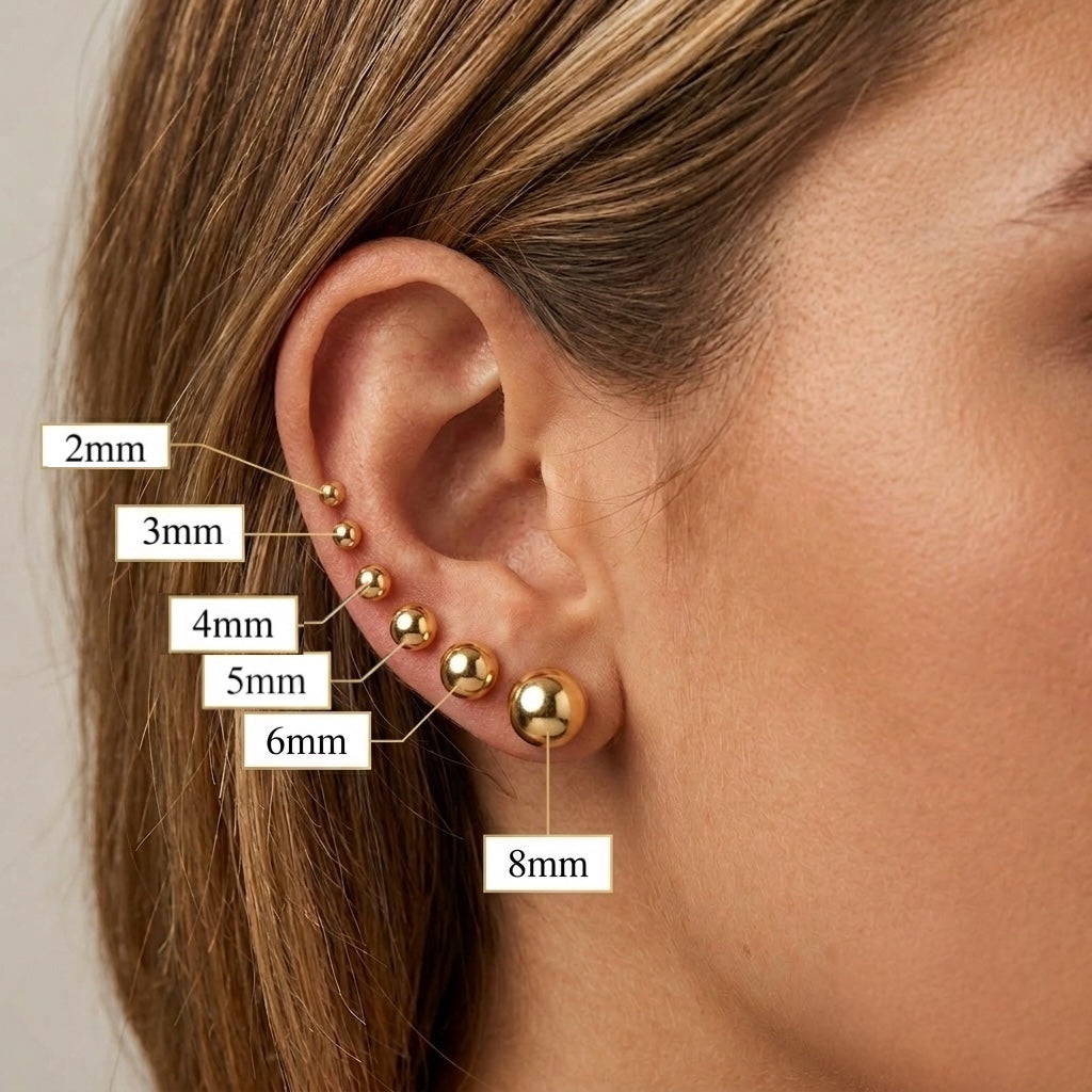 Gold earrings of different sizes worn on an ear with labeled measurements.