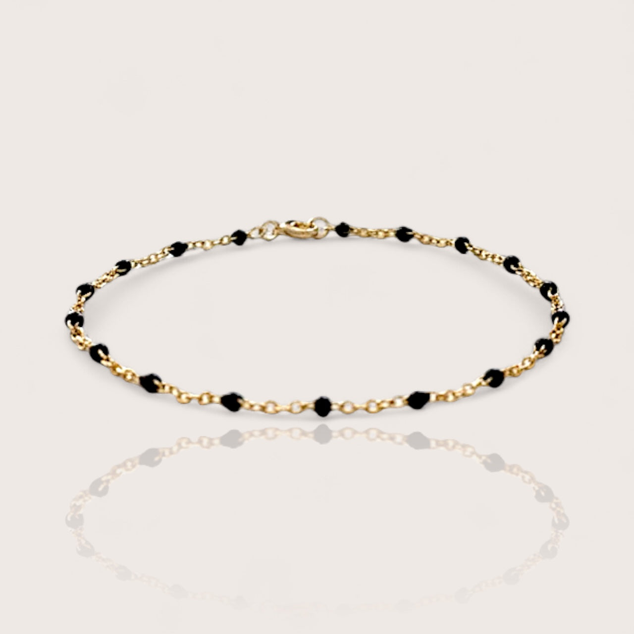 Dainty Station Bracelet in 14k gold filled chain with black enamel resin beads spaced out evenly with a spring-clasp closure
