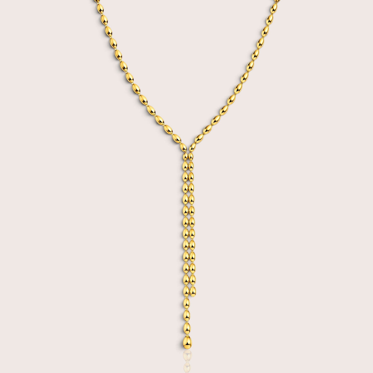 Gold Oval-Bead Y Lariat Necklace displayed on a light background by Ashley Nicole Jewelry
