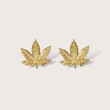 Close up front view of gold marijuana leaf stud earrings in 14K Yellow Gold