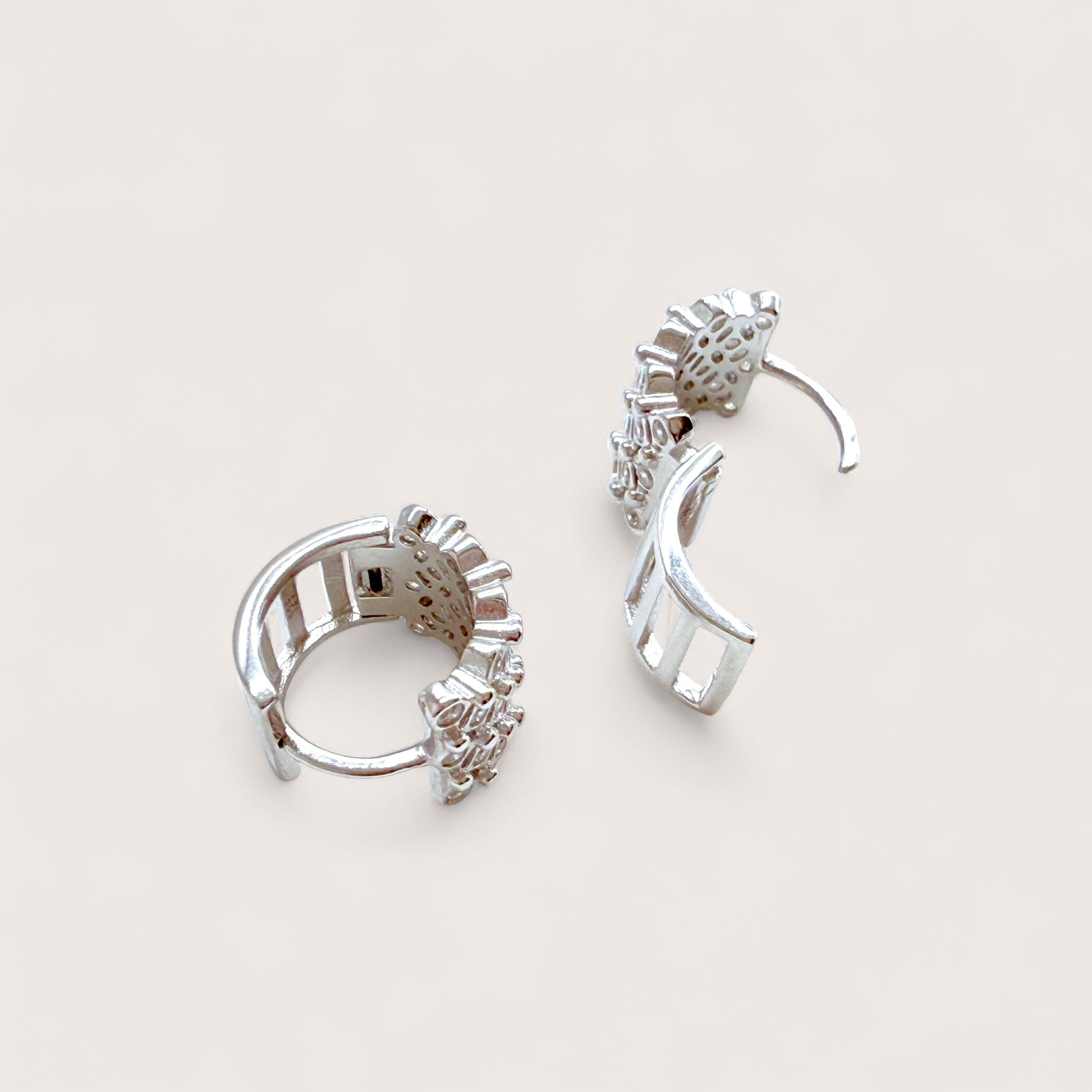 side view of hinged silver huggie hoop earrings