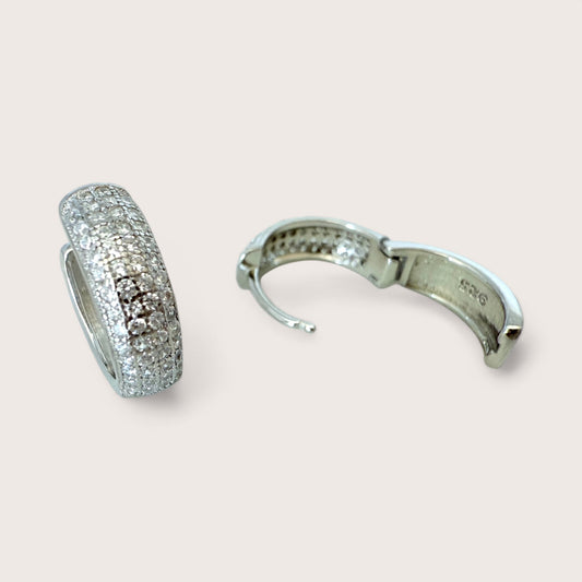 Close-up of sterling silver pavé huggie hoop clasp detail