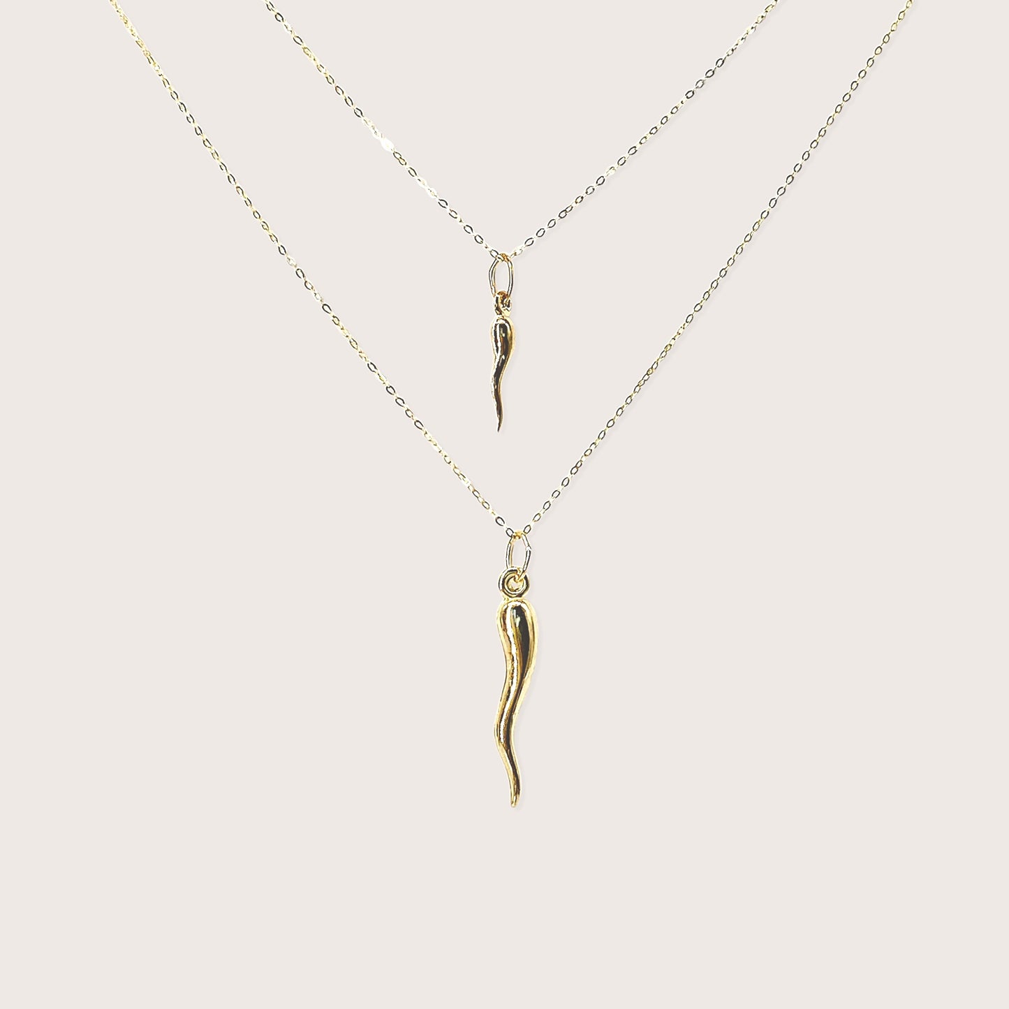 Solid 14K yellow gold large Italian horn cornicello pendant necklace on white background