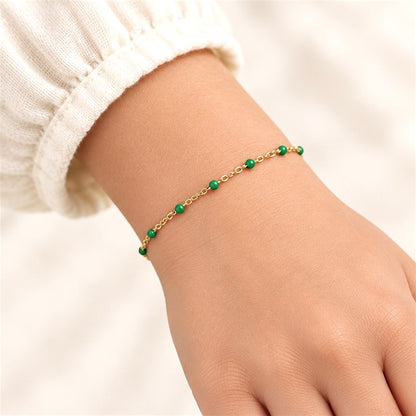 Emerald green enamel and 14K gold-filled bracelet on a child-sized wrist