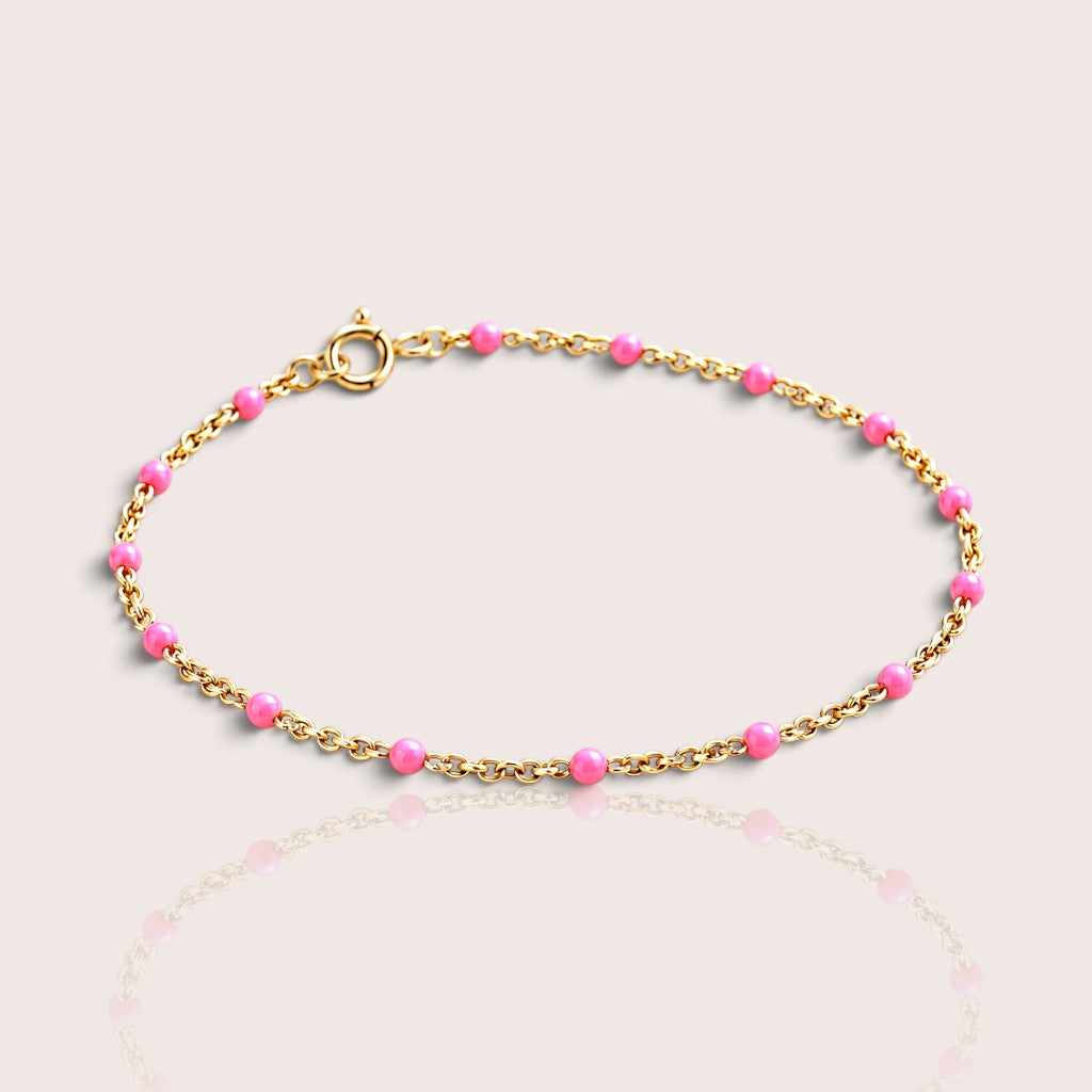 Elevated studio view of a kids’ light pink enamel bracelet with a 14K gold-filled chain