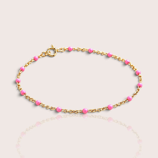 Elevated studio view of a kids’ light pink enamel bracelet with a 14K gold-filled chain