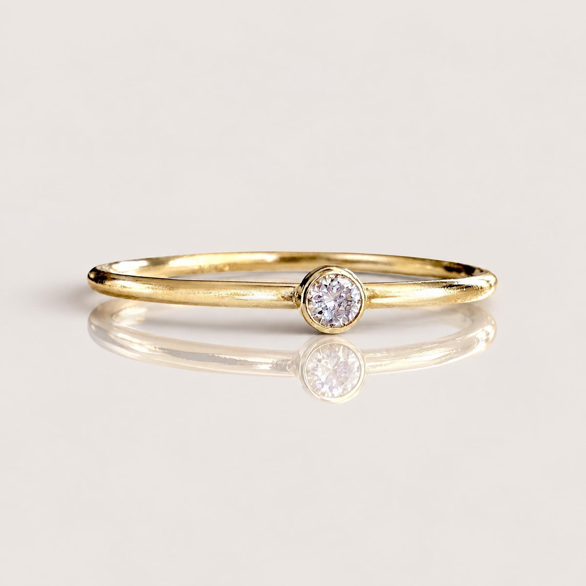 Macro close-up front view of brilliant cut VS DEF 2.0mm lab grown diamond set in smooth 14K gold filled bezel | Ashley Nicole Jewelry