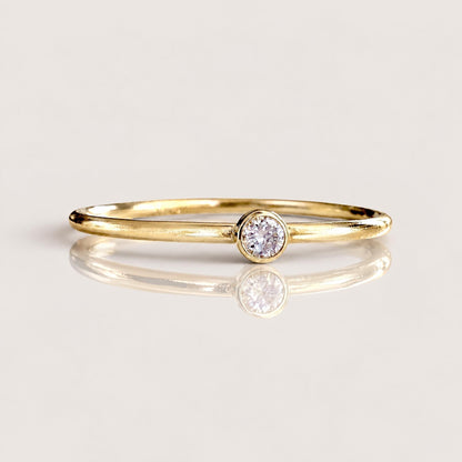 Macro close-up front view of brilliant cut VS DEF 2.0mm lab grown diamond set in smooth 14K gold filled bezel | Ashley Nicole Jewelry