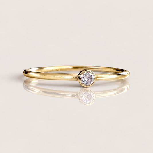 Macro close-up front view of brilliant cut VS DEF 2.0mm lab grown diamond set in smooth 14K gold filled bezel | Ashley Nicole Jewelry