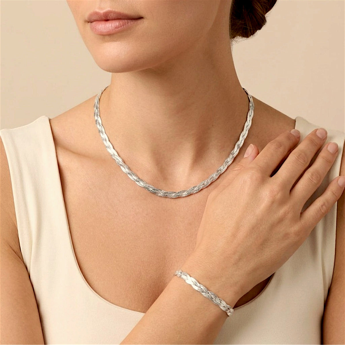 Model wearing a matching silver braided herringbone necklace and bracelet