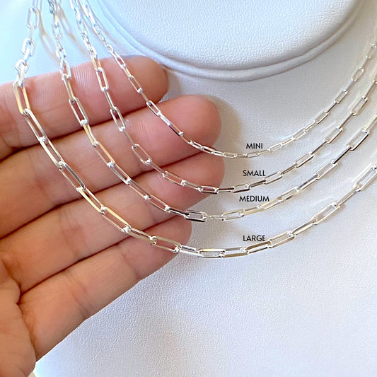 Close up of Sterling Silver Paperclip Chains with size labels, mini, small, medium and large 