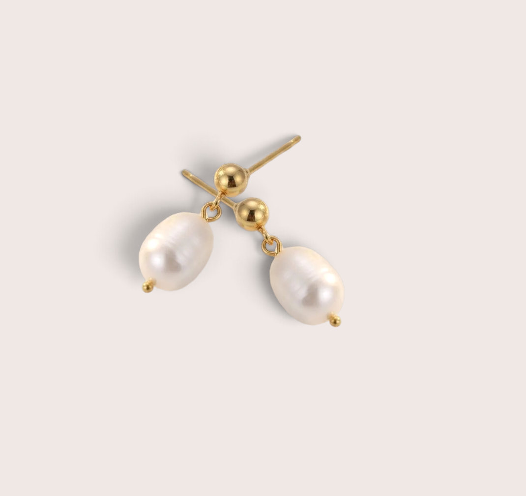 Close-up of an 18K gold ball stud and 10.5mm irregular freshwater baroque pearl drop earring