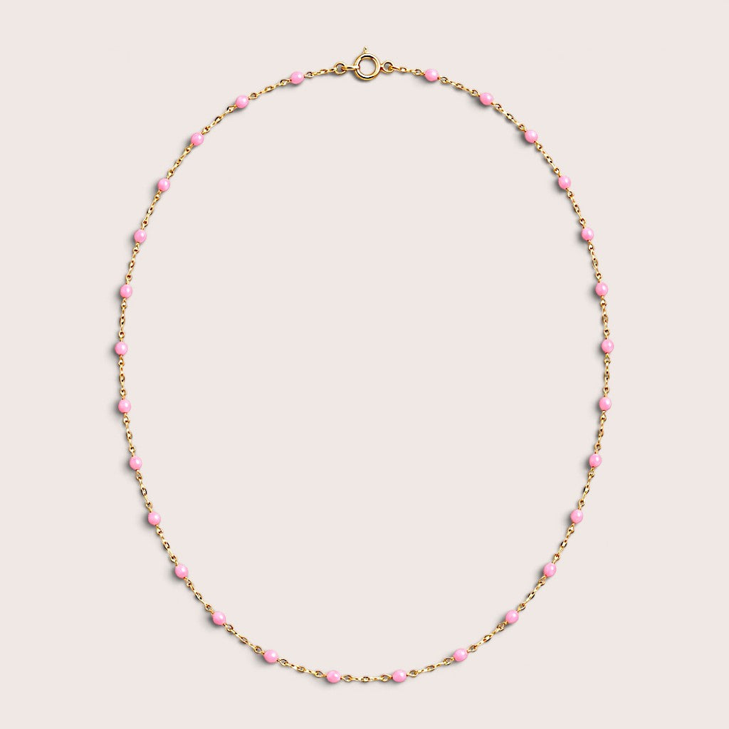 Pink enamel station beads spaced along a gold-filled necklace