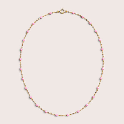 Pink enamel station beads spaced along a gold-filled necklace