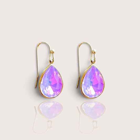 Close up view of a pair of pink opalescent faceted crystal teardrop dangle earrings with 14k gold-filled French wire hooks by Ashley Nicole Jewelry