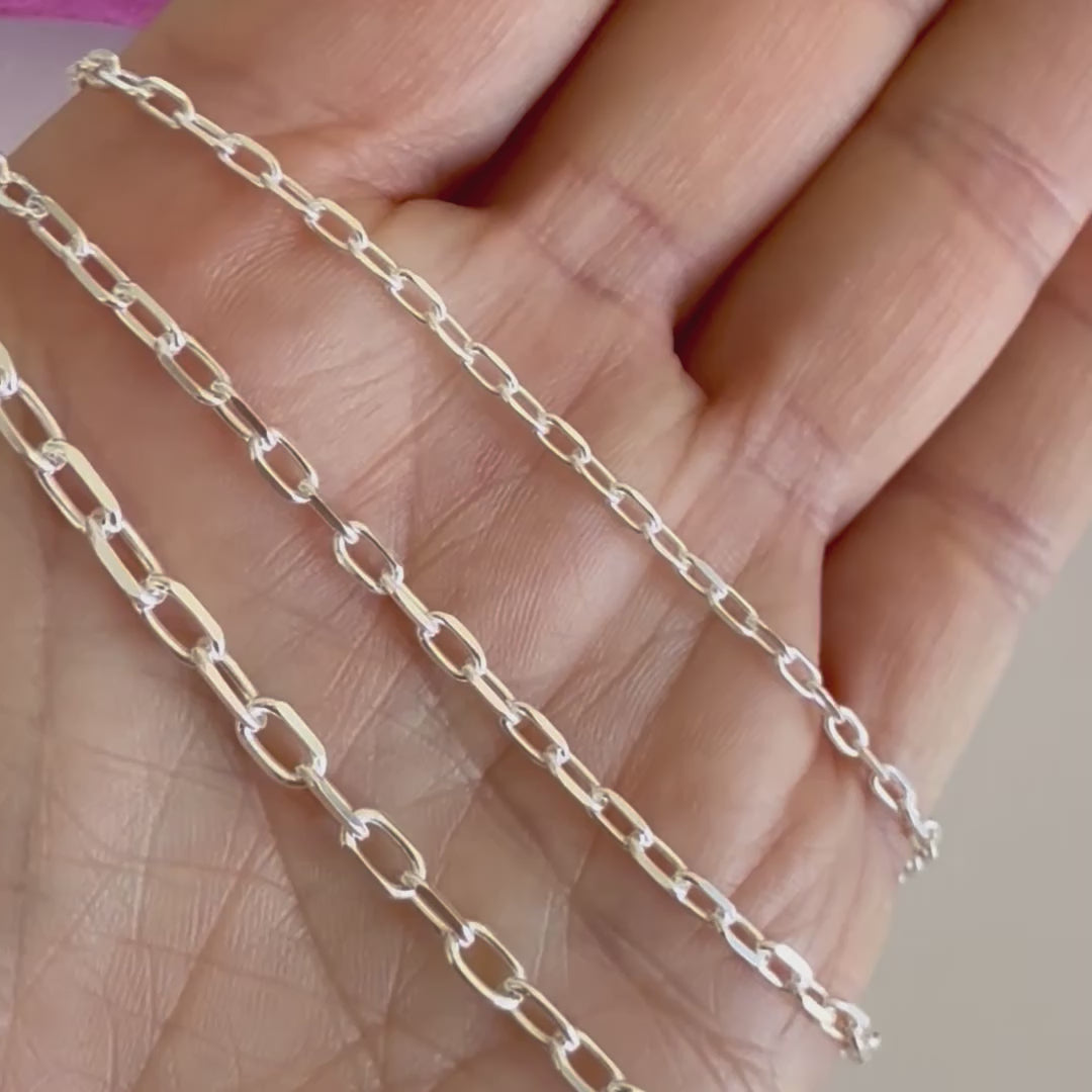 Close up video of  solid 925 sterling silver mariner  link chains in a hand by AshleyNicole Jewelry