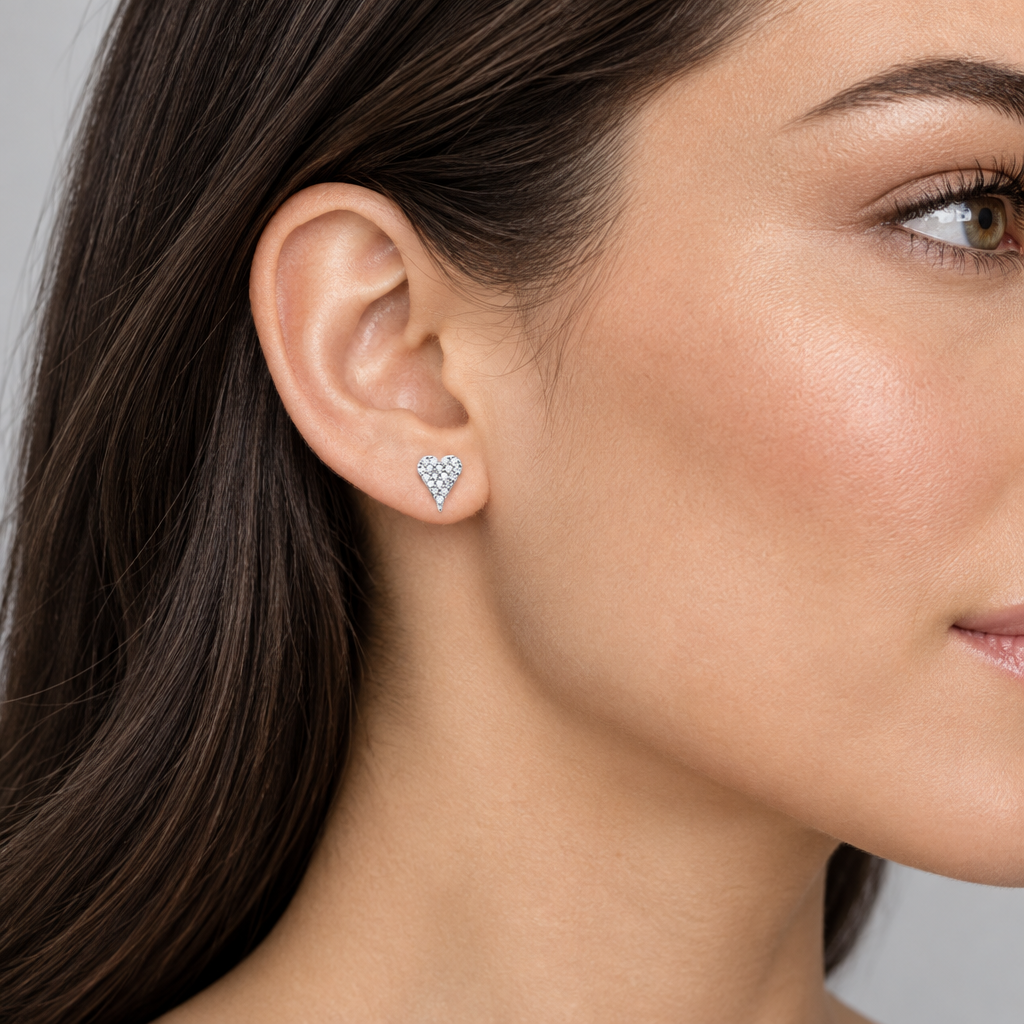 Model wearing 14K white gold pavé diamond heart stud earrings