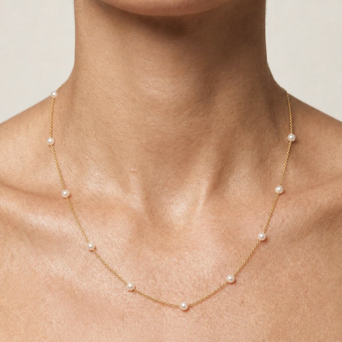 Model wearing the 18-inch gold-filled freshwater pearl station necklace