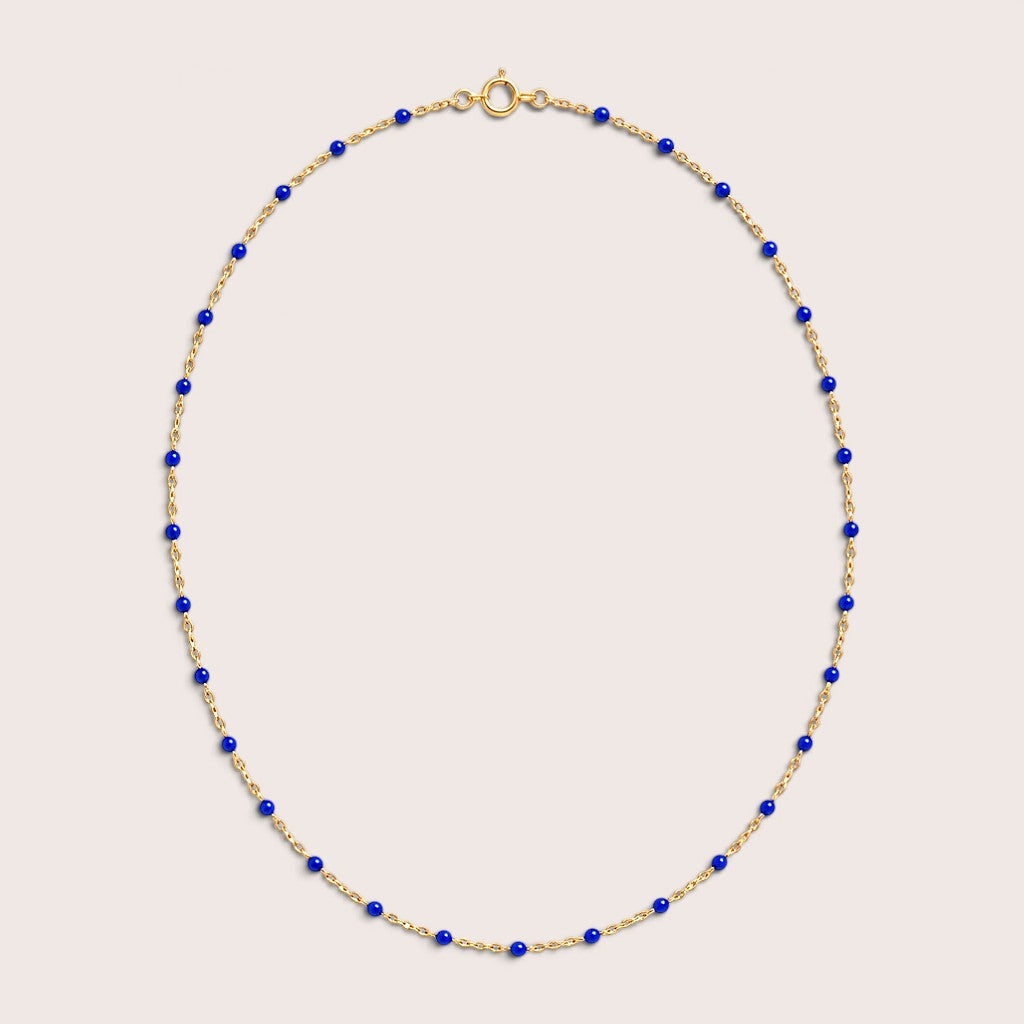 Sapphire blue enamel station beads spaced along a gold-filled necklace
