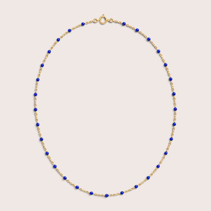 Sapphire blue enamel station beads spaced along a gold-filled necklace