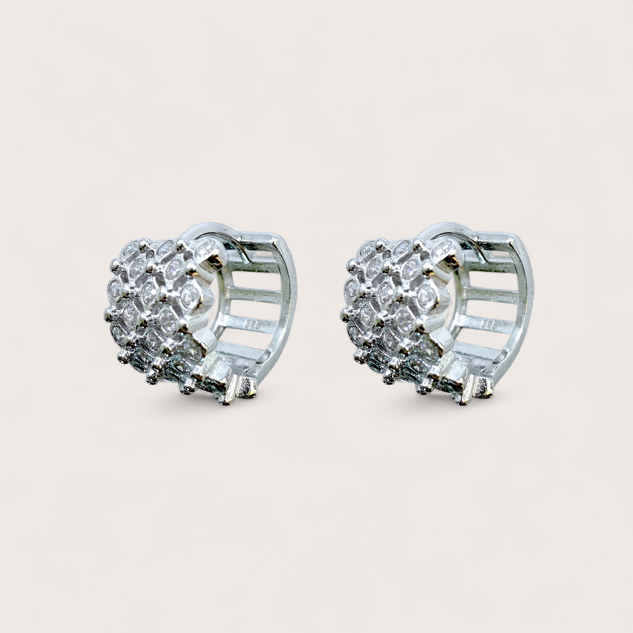 close up of huggie earrings with cubic zirconia