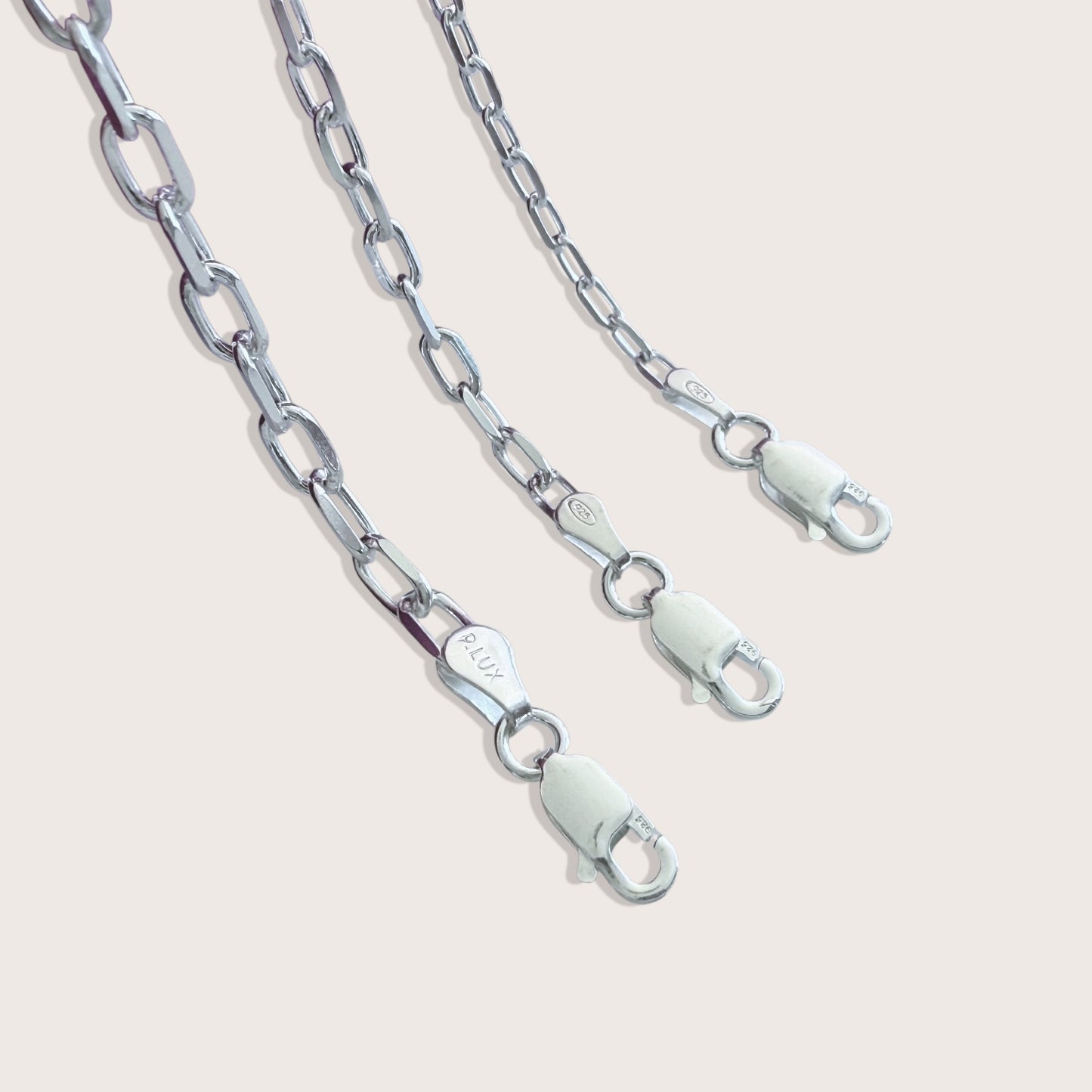 Close up view of the heavy duty Italian lobster claw clasp on a solid 925 sterling silver mariner chain bracelet by Ashley Nicole Jewelry.